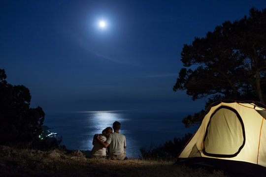 Couple at moon night near tent