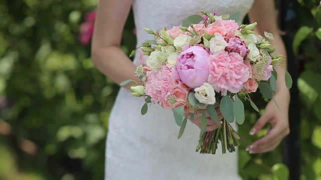 Bridal Bouquet Of Flowers In Hands Of The Bride