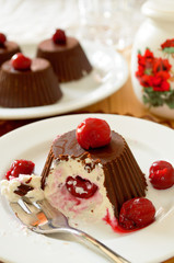 Homemade custard ice cream, covered with chocolate and cherries