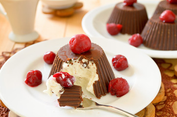 Homemade custard ice cream, covered with chocolate and cherries