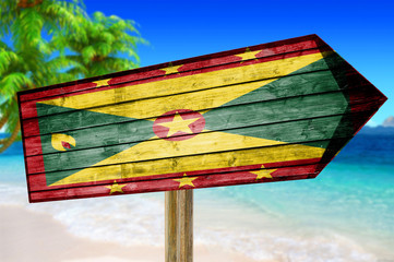 Grenada Flag wooden sign on beach background