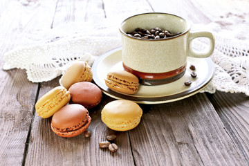 Morning coffee with macaroons on wooden table
