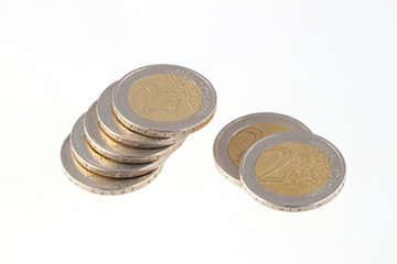 Close up photo of two Euro coins on a plain white background.