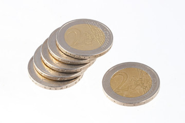 Close up photo of two Euro coins on a plain white background.