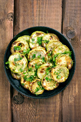 Fried zucchini on wooden table