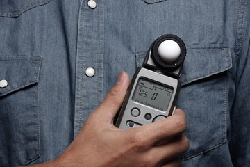 photographer holding a light meter