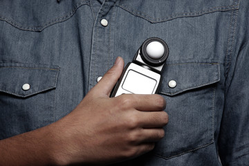 photographer holding a light meter