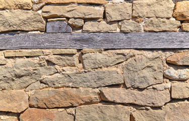 Stone wall background with wooden beams