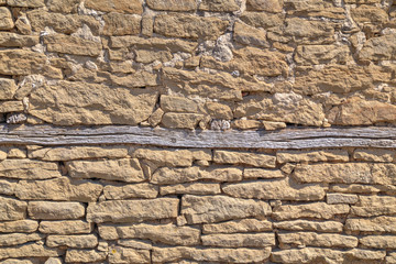 Stone wall background with wooden beams