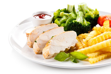 Grilled chicken fillet and vegetables on white background 