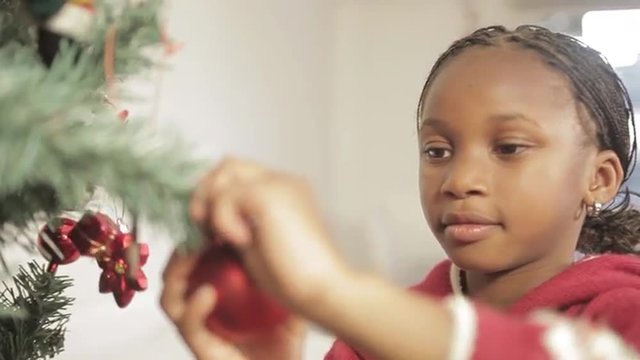 Girl decorating the christmas tree