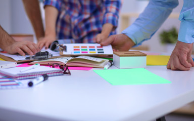 Fototapeta premium Close-up of three young creative designers working on project