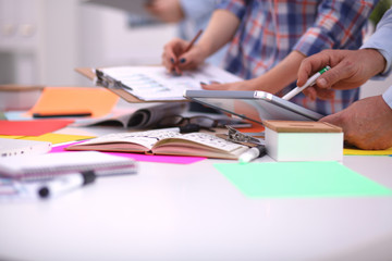 Close-up of three young creative designers working on project