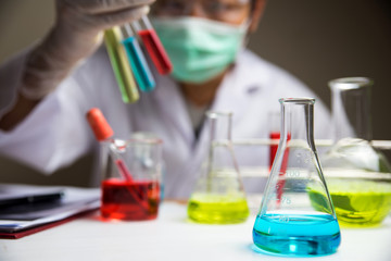 Laboratory glassware with out of focus scientist background 