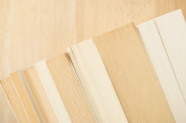 books and manuals side view close up - soft natural wood background