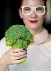 closeup of woman holding broccoli