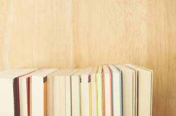 books and manuals side view close up - soft natural wood background