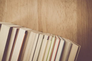 books and manuals side view close up - soft natural wood background