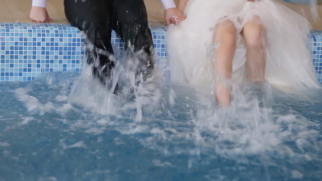 The bride and groom  in the pool