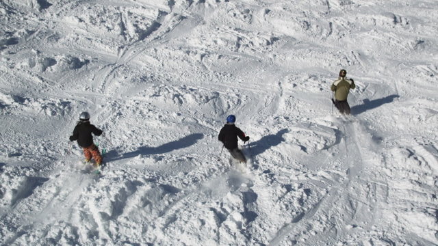 skiers skiing down the slopes at a ski resort