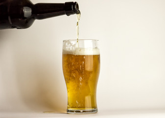Beer is poured into a glass