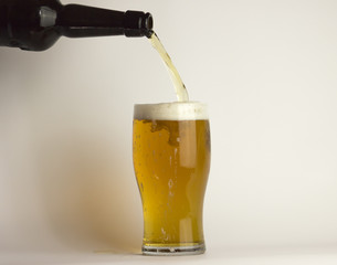 Beer is poured into a glass