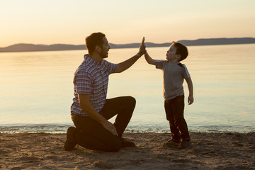 Father with is son at the sunset