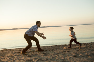 Fototapeta premium Father with is son at the sunset