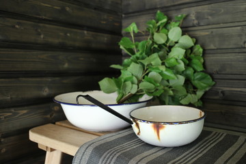 Sauna interior. Traditional sauna from Finland. Equipment and birch whisk. Whisk is used for body massage.