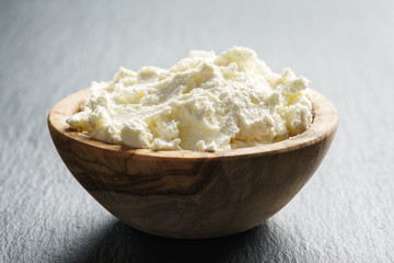 creamy cheese in wooden bowl