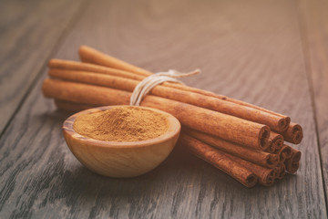 bunch of cinnamon sticks tied with twine, on rustic table