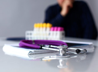 Medical doctor  sitting at table and looking patients roentgen