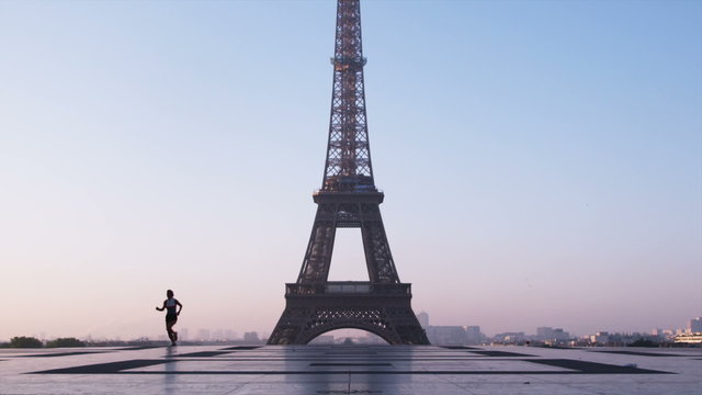 woman running in front of the Eiffel tower