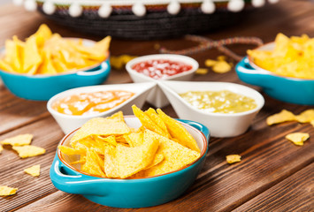 Plate of nachos with different dips