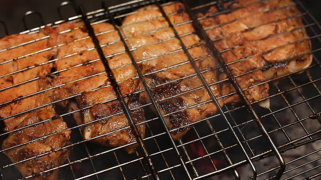 Meat on the grill with flames closeup