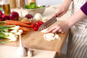 Young Woman Cooking in the kitchen. Healthy Food