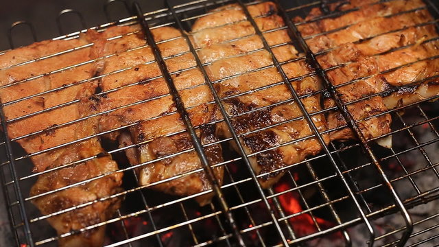 Meat on the grill with flames closeup
