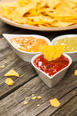 Plate of nachos with different dips