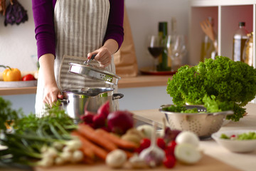 Young Woman Cooking in the kitchen. Healthy Food