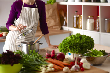 Young Woman Cooking in the kitchen. Healthy Food