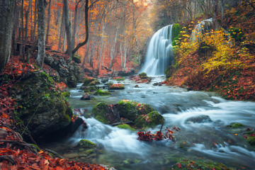 Beautiful waterfall in autumn forest in crimean mountains at sun