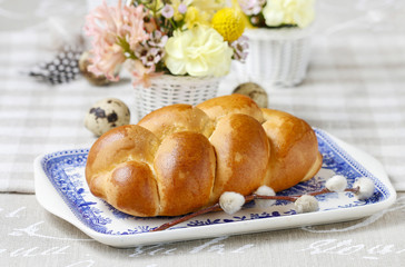 Easter bun and beautiful decorations with spring flowers in the