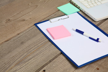 blank notebook on wooden table with pencils