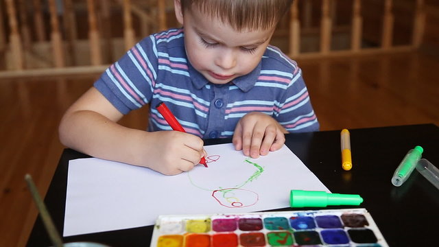 Little boy paints