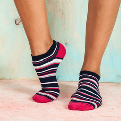 beautiful legs woman with socks standing on tiptoe on the wooden floor