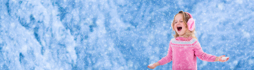 Little girl playing in snowy park