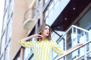 Fototapeta premium Beautiful young girl posing on city street