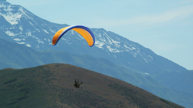WS PAN POV Person paragliding over mountain / Lehi, Utah, USA.