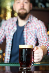 Portrait of handsome bartender at workplace