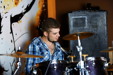 Excited drummer on bright background